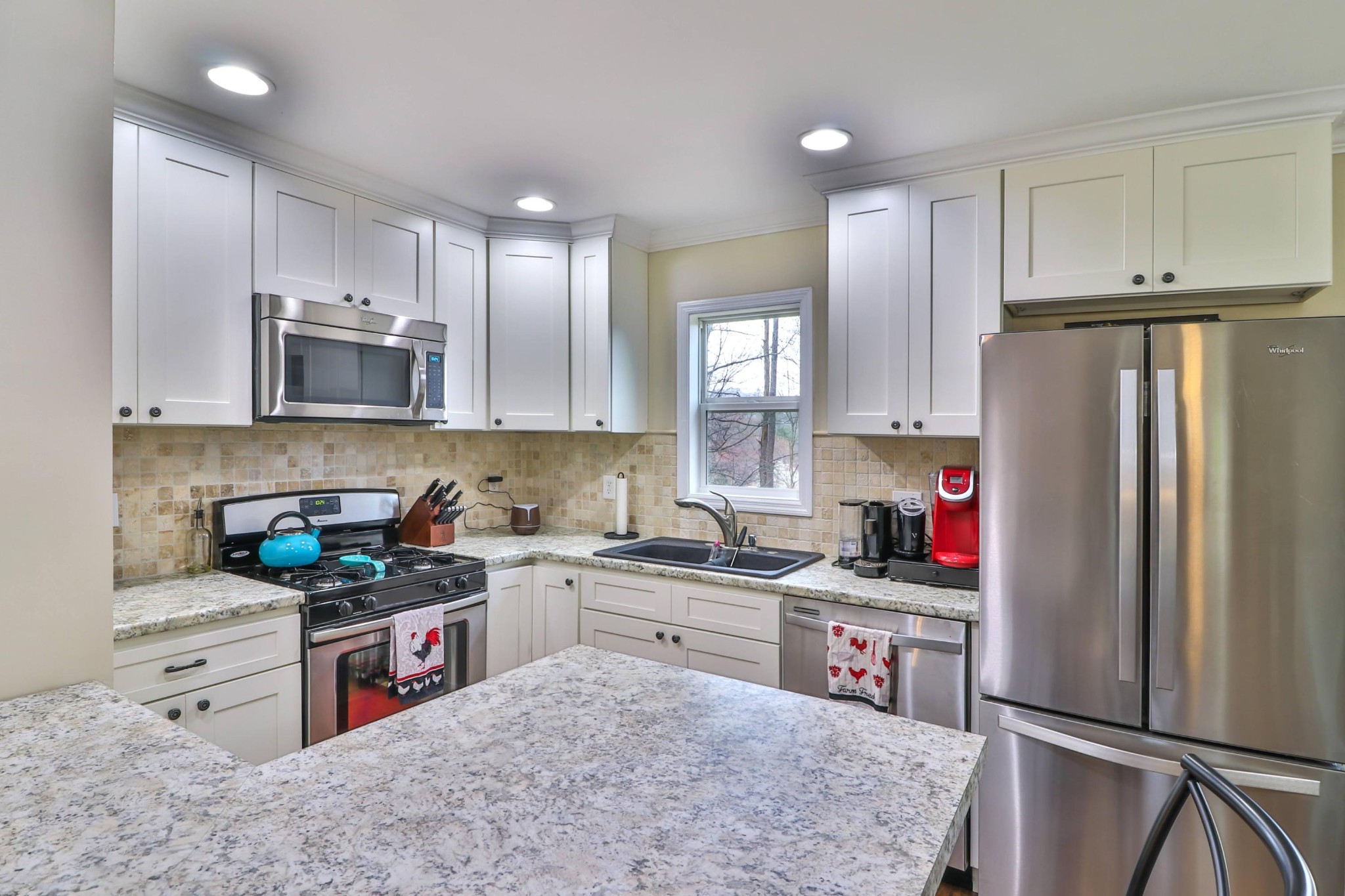 2212 Roundtree Road Knoxville, TN 37923 - Photo 8 of 27 a kitchen with stainless steel appliances granite countertop a stove refrigerator sink and microwave
