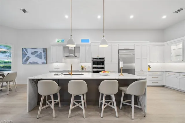a kitchen that has a table and chairs in it
