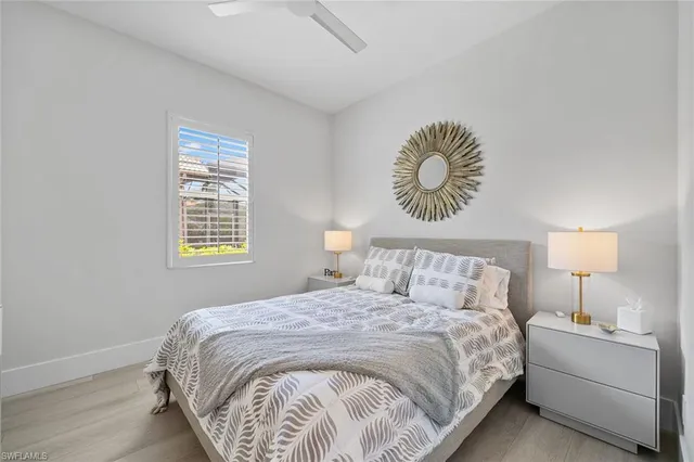 a bedroom with a bed and a lamp on dresser