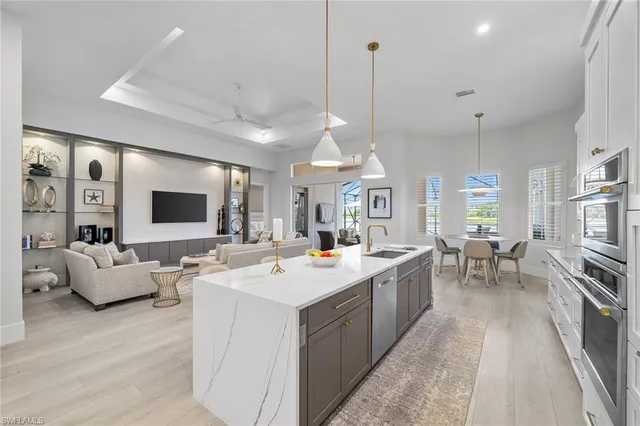 a large kitchen with kitchen island a sink dining table and chairs