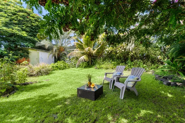 a backyard of a house with table and chairs