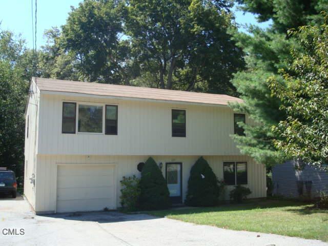 153 Dry Hill Road Norwalk, CT 06851 - Photo 1 of 1 a front view of a house with a garden