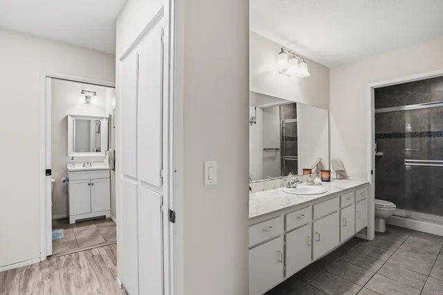 a spacious bathroom with a double vanity sink a mirror and a bathtub