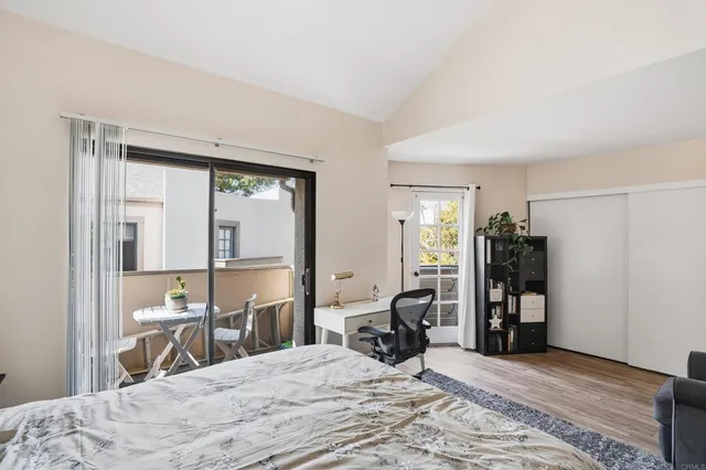 a room with a bed and a large window