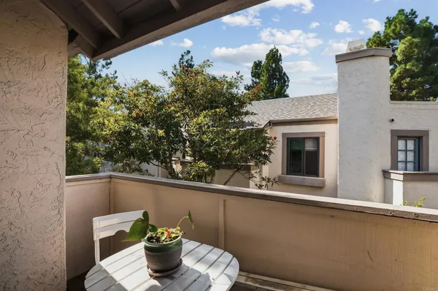 a side view of a house with outdoor seating