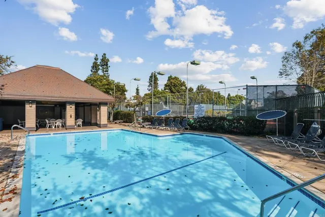 a view of a house with swimming pool and sitting area