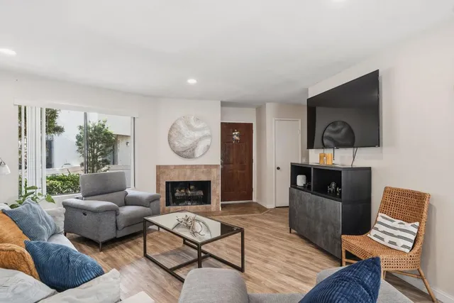a living room with furniture fireplace and a flat screen tv