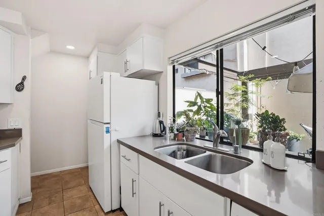 a kitchen with a sink and refrigerator