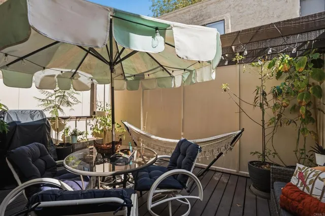 a balcony with table and chairs