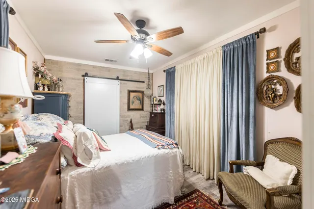 a bedroom with a bed couch and a window