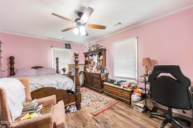 a bed room with a bed mirror and a ceiling fan