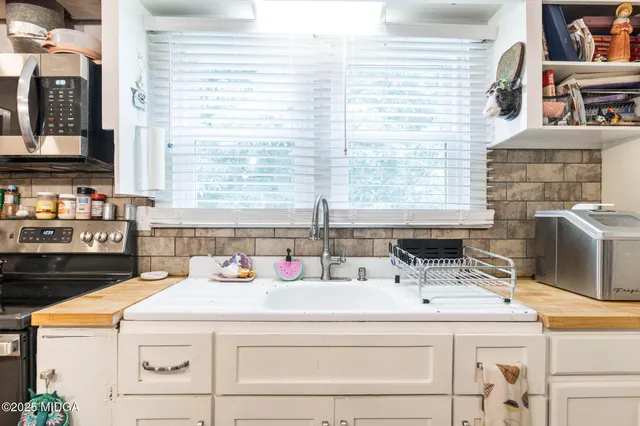a utility room with a sink and a stove