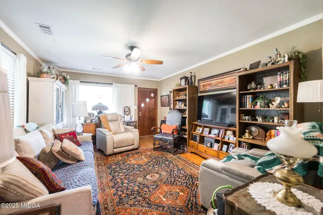 a living room with furniture and a flat screen tv