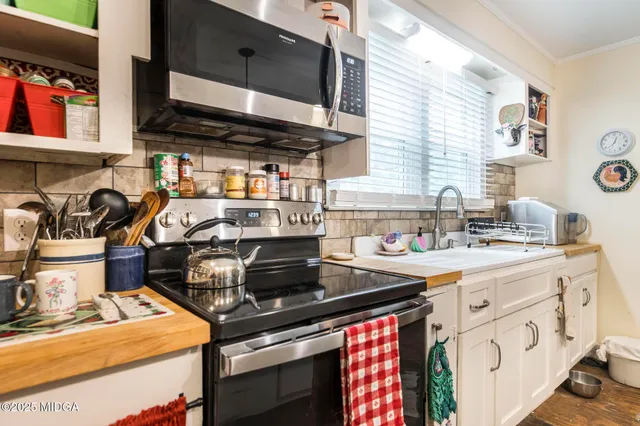 a kitchen with a stove and a microwave
