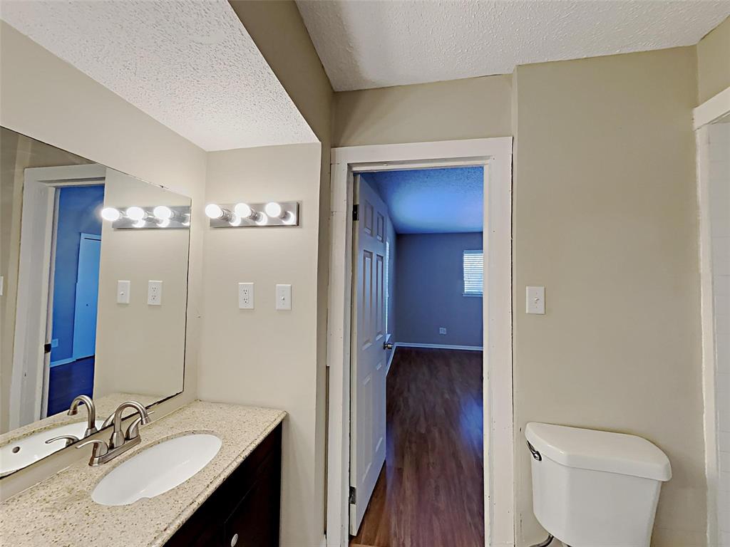 2330 Farm To Market Road 1387 Midlothian, TX 76065 - Photo 12 of 17 a bathroom with a granite countertop sink toilet and shower