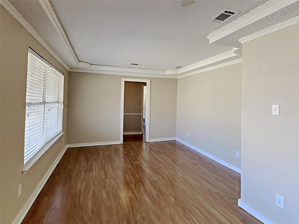 2330 Farm To Market Road 1387 Midlothian, TX 76065 - Photo 15 of 17 a view of an empty room with wooden floor and a window