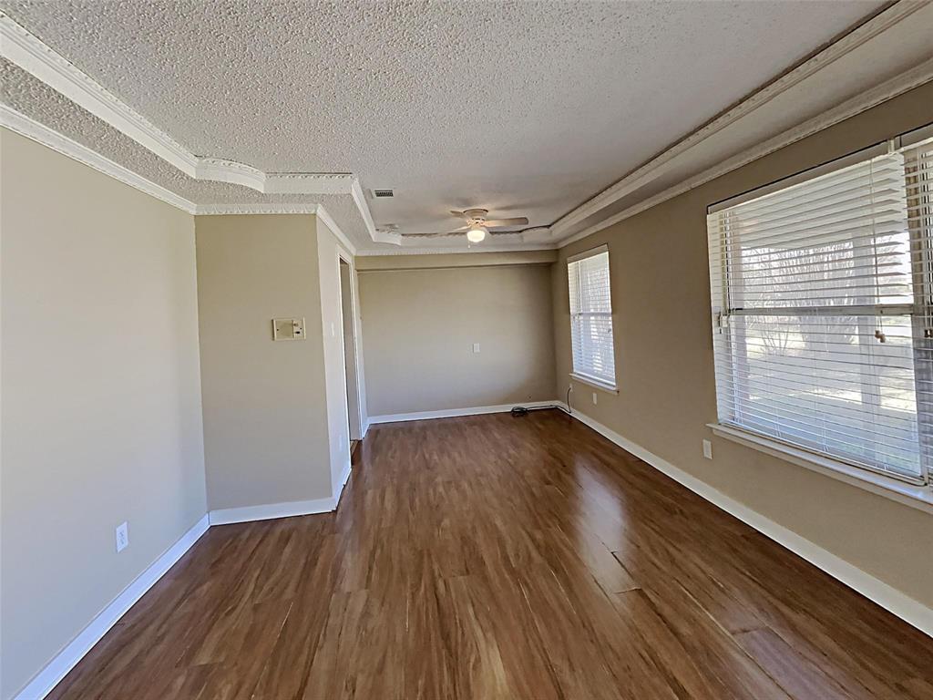 2330 Farm To Market Road 1387 Midlothian, TX 76065 - Photo 3 of 17 a view of an empty room with wooden floor and a window