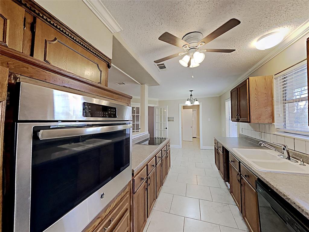 2330 Farm To Market Road 1387 Midlothian, TX 76065 - Photo 4 of 17 a kitchen with stainless steel appliances a sink and a refrigerator