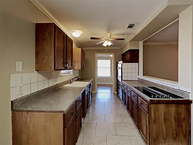 a kitchen with stainless steel appliances granite countertop a stove and a refrigerator