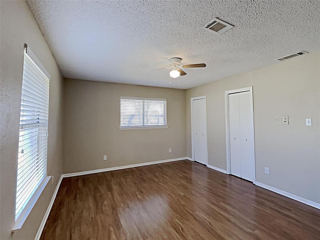 2330 Farm To Market Road 1387 Midlothian, TX 76065 - Photo 8 of 17 a view of an empty room with wooden floor and a window