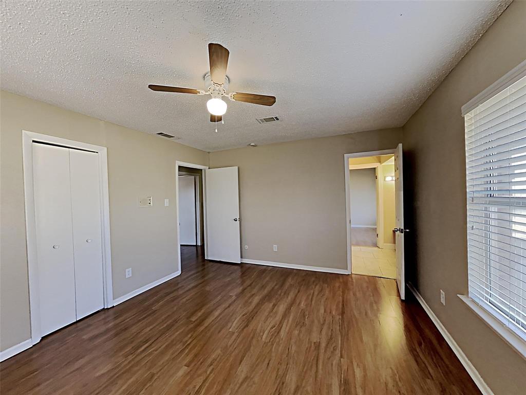 2330 Farm To Market Road 1387 Midlothian, TX 76065 - Photo 9 of 17 a view of an empty room with wooden floor and a window