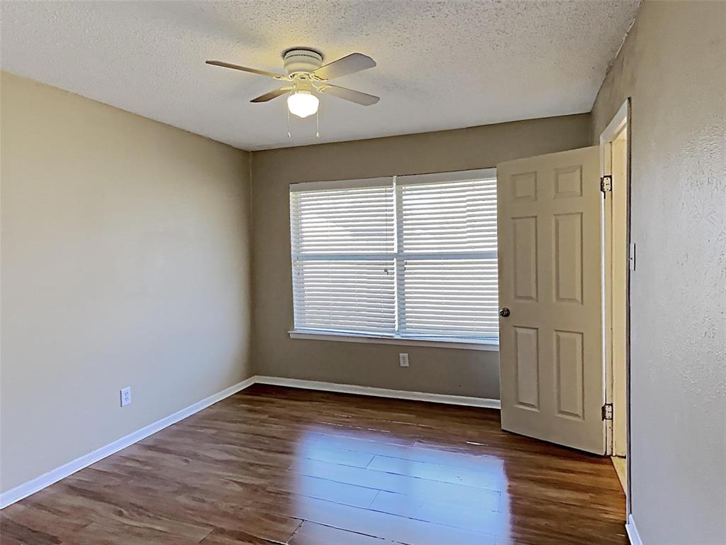 2330 Farm To Market Road 1387 Midlothian, TX 76065 - Photo 10 of 17 an empty room with wooden floor and windows
