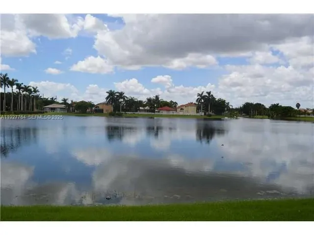 a view of a lake with houses in the back