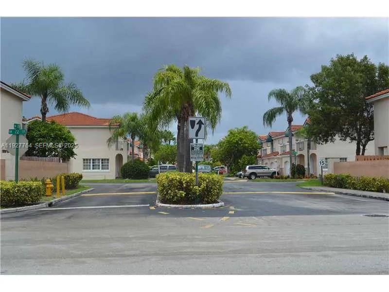 7132 Southwest 158th Path Miami, FL 33193 - Photo 14 of 21 a front view of a house with garden