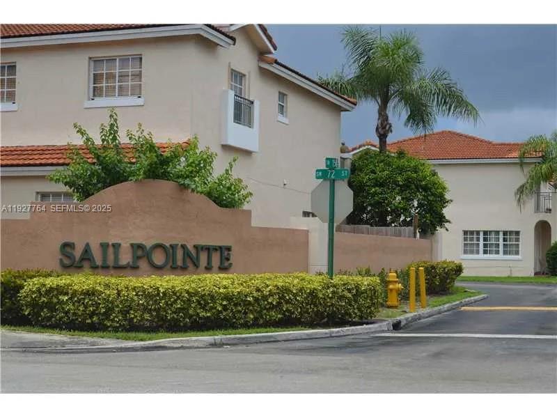 7132 Southwest 158th Path Miami, FL 33193 - Photo 2 of 21 a front view of a house with a yard and garage
