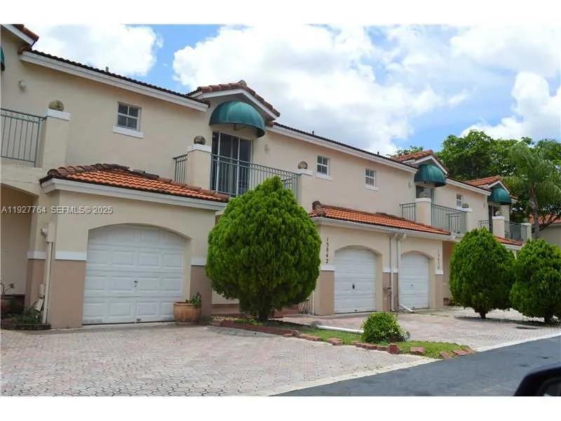 7132 Southwest 158th Path Miami, FL 33193 - Photo 3 of 21 a view of a white house with a small yard and a large parking space