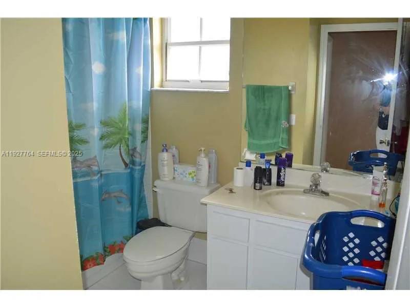 7132 Southwest 158th Path Miami, FL 33193 - Photo 10 of 21 a bathroom with a sink vanity granite toilet and shower