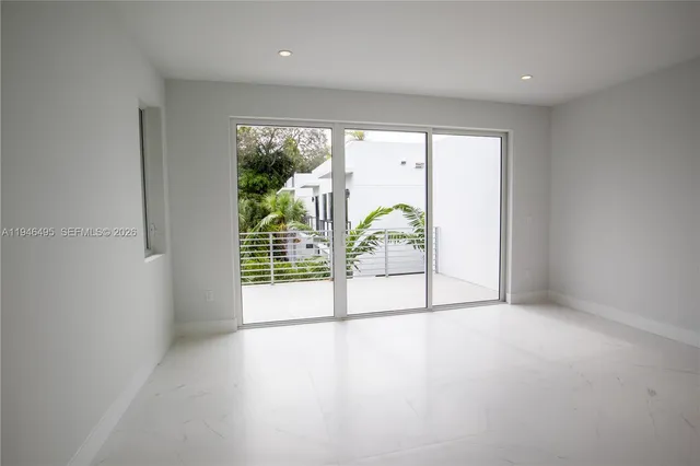an empty room with sliding glass door and mountain view