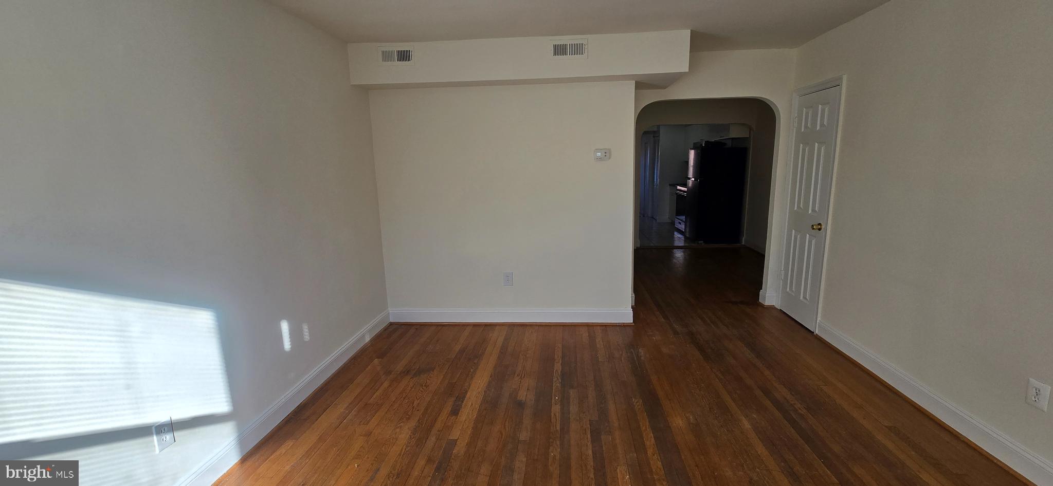 1516 F Street Northeast, Unit 3 Washington, DC 20002 - Photo 2 of 14 a view of an empty room with wooden floor and a window