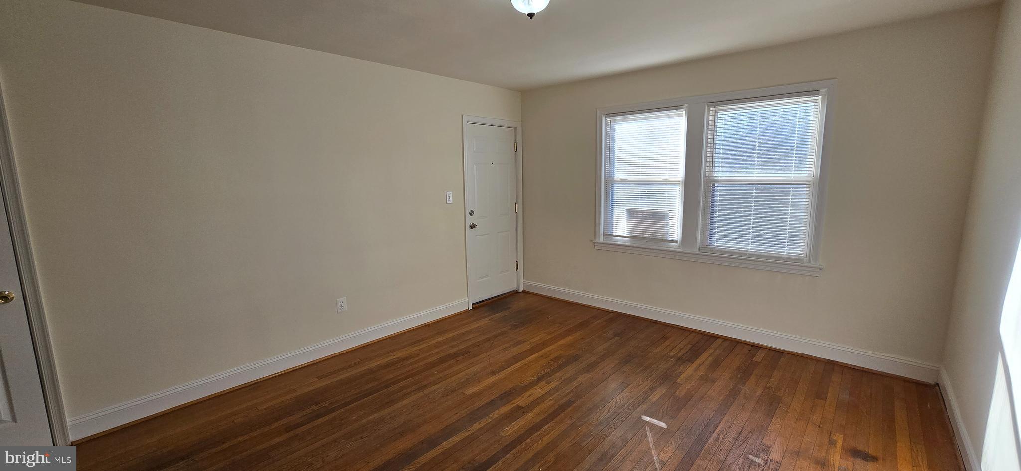 1516 F Street Northeast, Unit 3 Washington, DC 20002 - Photo 3 of 14 a view of an empty room with wooden floor and a window