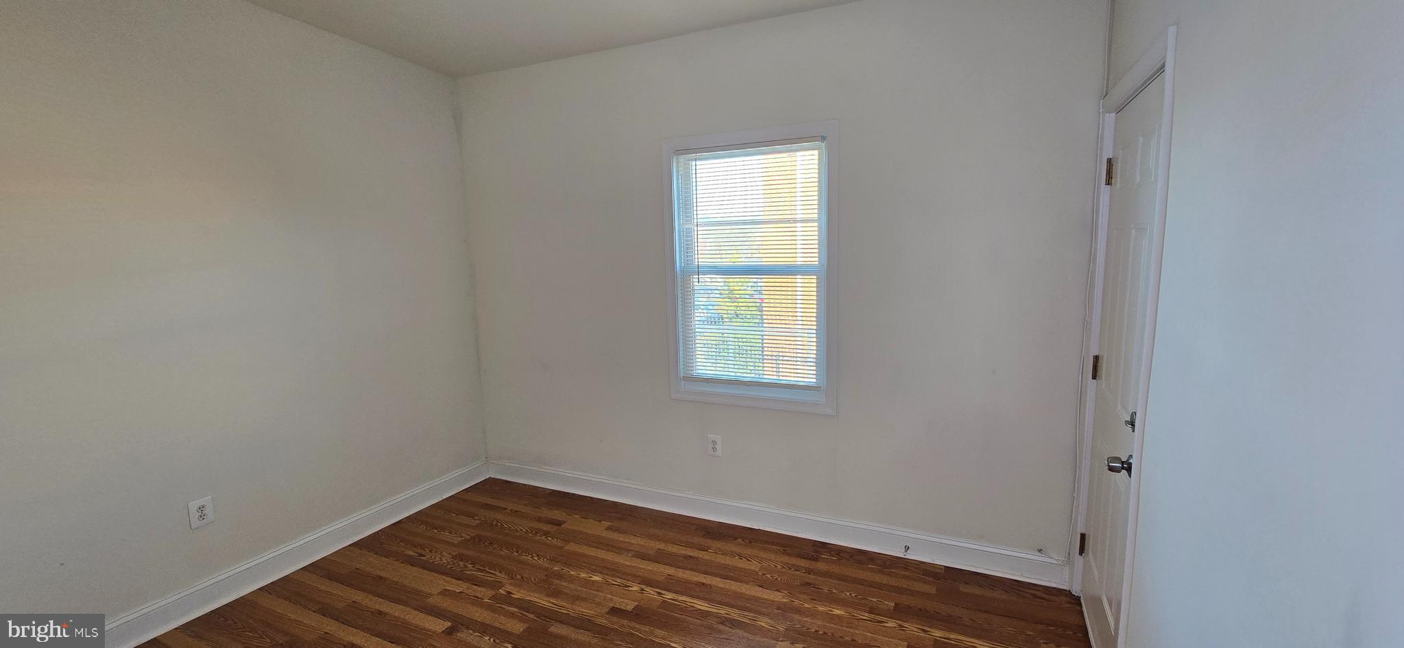 1516 F Street Northeast, Unit 3 Washington, DC 20002 - Photo 9 of 14 a view of an empty room with wooden floor and a window