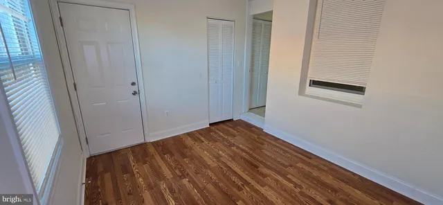 a view of a room with wooden floor and staircase