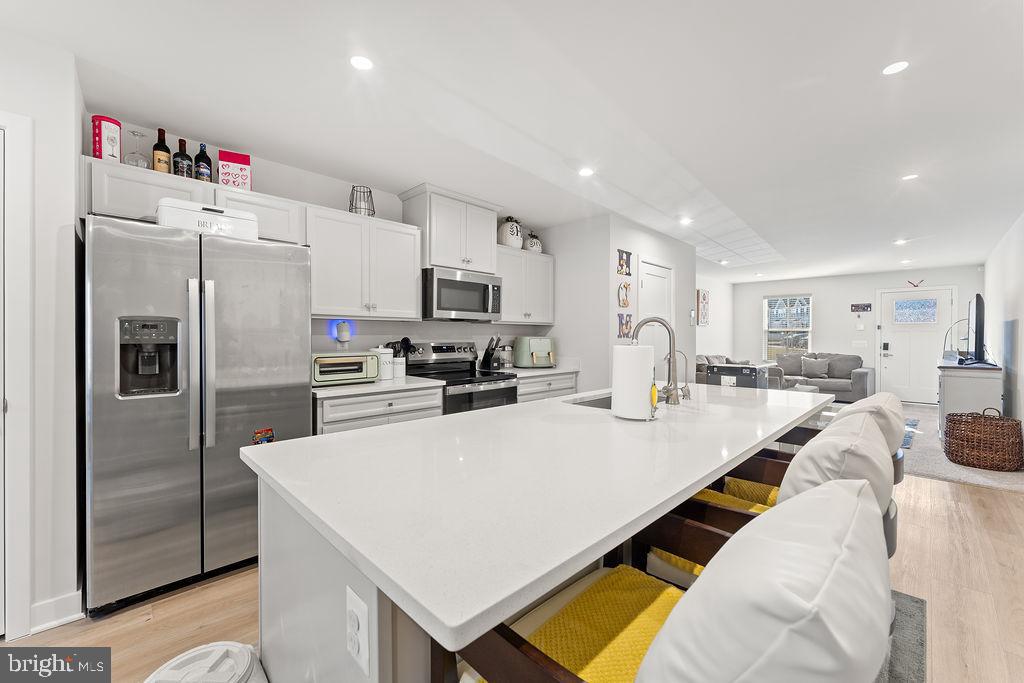 18368 Centennial Circle Ruther Glen, VA 22546 - Photo 12 of 45 a kitchen with stainless steel appliances a refrigerator sink stove microwave and cabinets