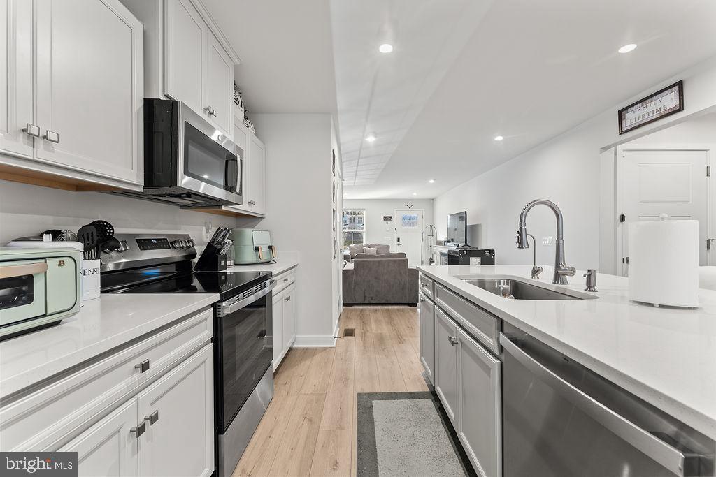 18368 Centennial Circle Ruther Glen, VA 22546 - Photo 13 of 45 a kitchen with stainless steel appliances granite countertop a sink stove and cabinets