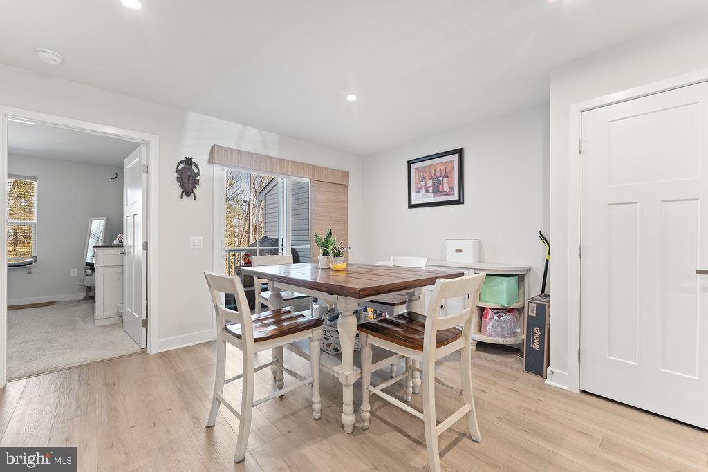18368 Centennial Circle Ruther Glen, VA 22546 - Photo 15 of 45 a view of a dining room with furniture and wooden floor