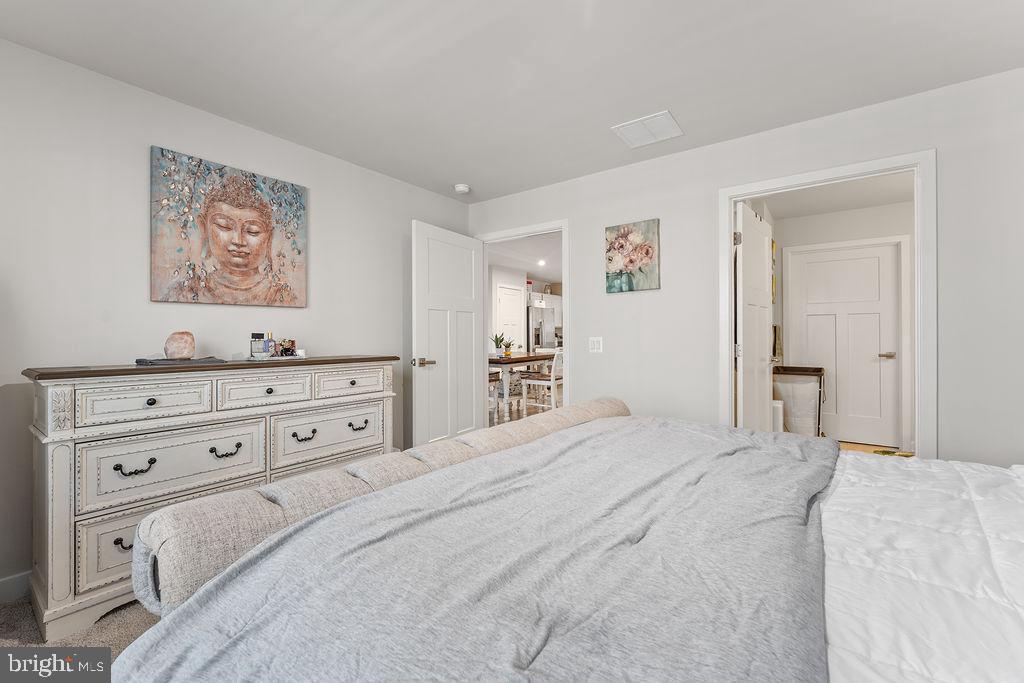 18368 Centennial Circle Ruther Glen, VA 22546 - Photo 18 of 45 a bedroom with a bed and a painting on the wall