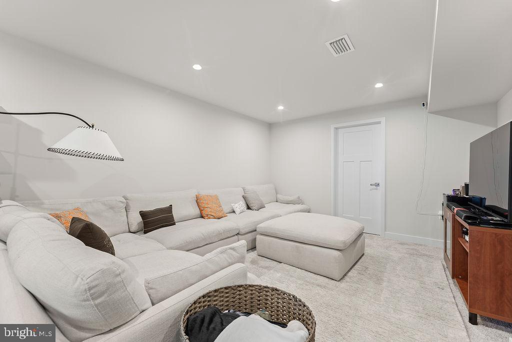 18368 Centennial Circle Ruther Glen, VA 22546 - Photo 33 of 45 a living room with furniture a couch and a flat screen tv