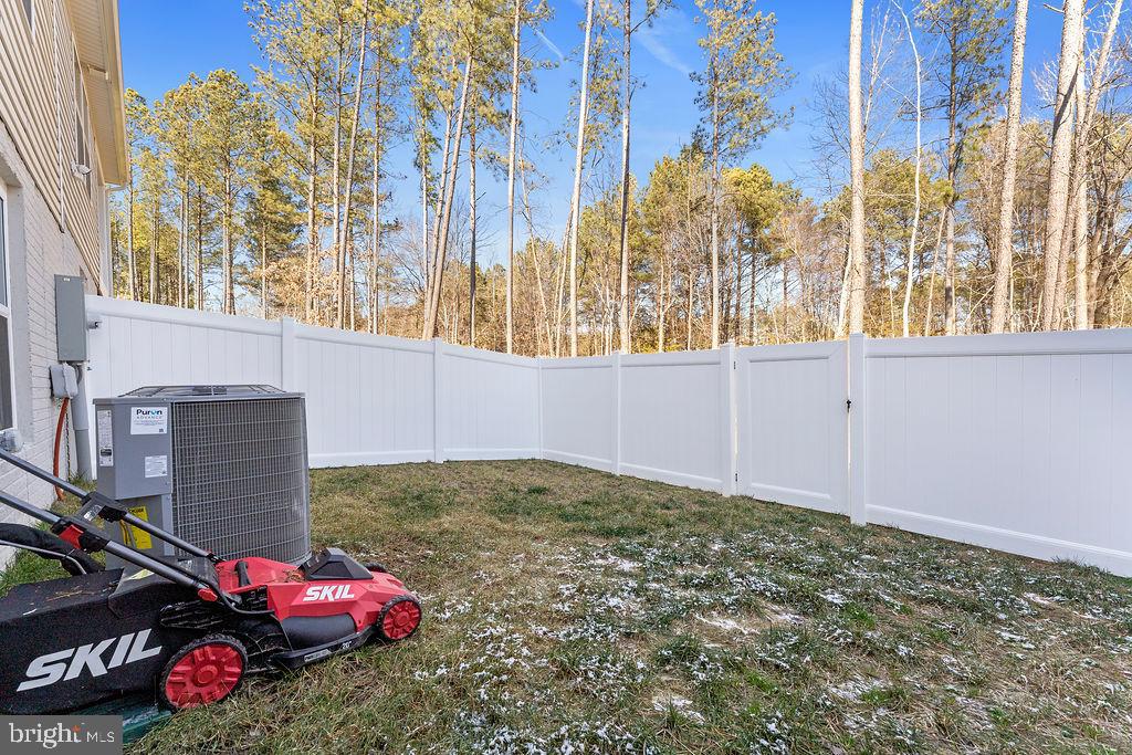 18368 Centennial Circle Ruther Glen, VA 22546 - Photo 40 of 45 a bedroom with a bed and a chandelier