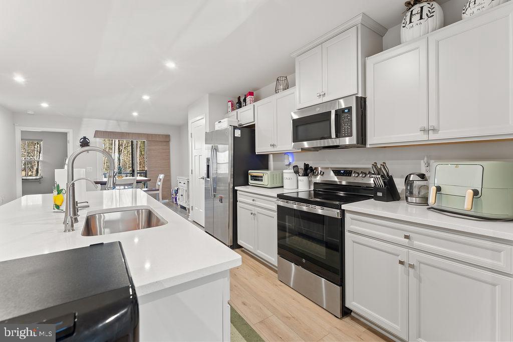 18368 Centennial Circle Ruther Glen, VA 22546 - Photo 9 of 45 a kitchen with granite countertop a sink and stainless steel appliances