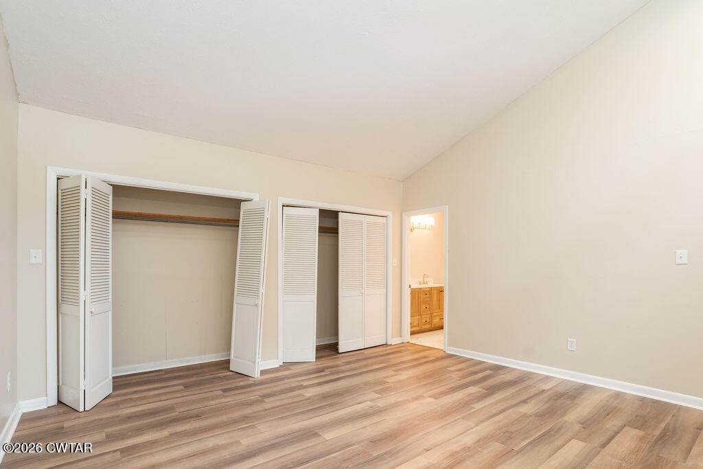 7 Timberlake Drive Jackson, TN 38305 - Photo 21 of 38 an empty room with wooden floor and windows