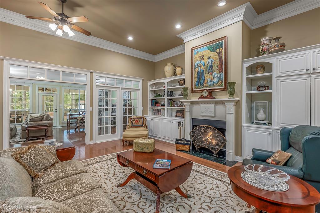 400 Crouch Road Benton, LA 71006 - Photo 13 of 40 Living area with a fireplace with flush hearth, wood finished floors, ornamental molding, a ceiling fan, and recessed lighting