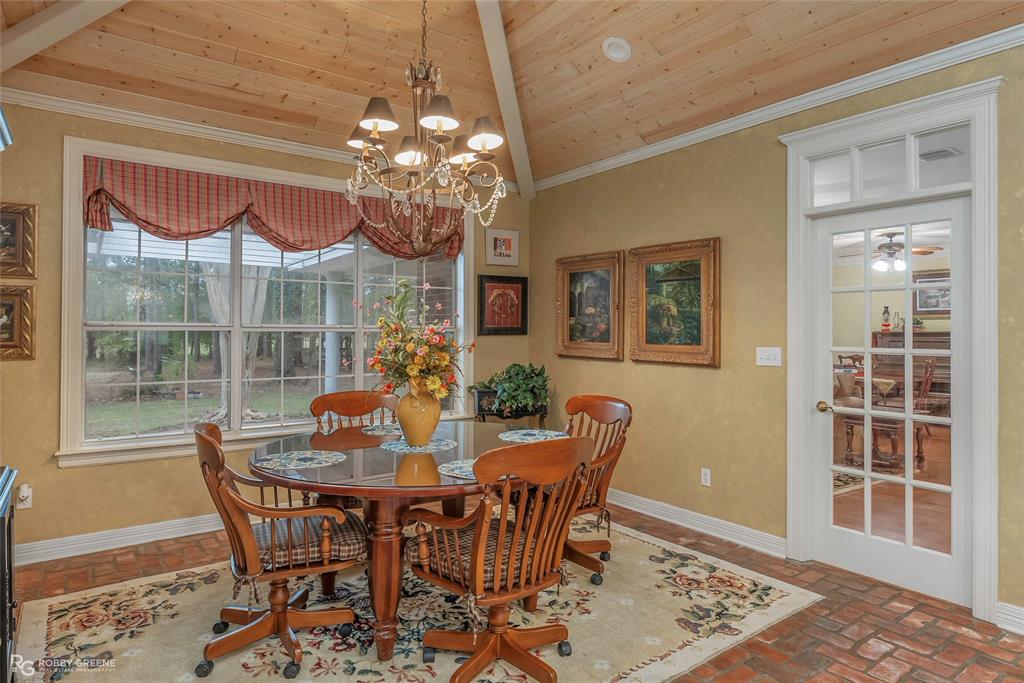 400 Crouch Road Benton, LA 71006 - Photo 15 of 40 a view of a dining room with furniture a chandelier and window