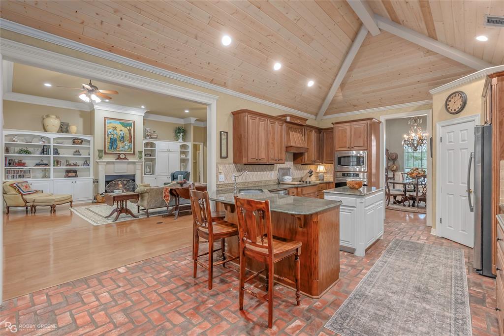 400 Crouch Road Benton, LA 71006 - Photo 16 of 40 Dining space featuring a decorative wall, wainscoting, ornamental molding, wood finished floors, and a textured wall