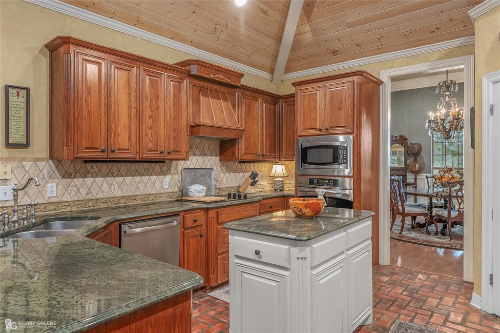 400 Crouch Road Benton, LA 71006 - Photo 17 of 40 a kitchen with stainless steel appliances granite countertop a sink stove and refrigerator