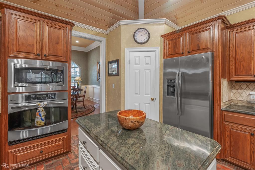 400 Crouch Road Benton, LA 71006 - Photo 40 of 40 a kitchen with stainless steel appliances granite countertop a refrigerator and a stove