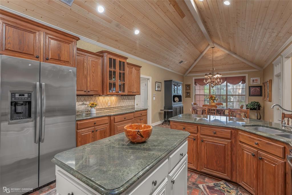 400 Crouch Road Benton, LA 71006 - Photo 18 of 40 a kitchen with stainless steel appliances granite countertop a sink stove and refrigerator